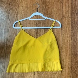 Yellow silk top with details on the bottom